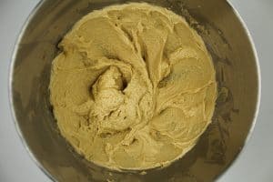 creamed butter and sugar mixture in a silver KitchenAid mixing bowl