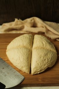 soft pretzel dough cut into 4 equal parts