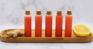 Watermelon Lemon Ginger Juice Wellness Shots Recipe. Tiny glass vials filled with the wellness shots