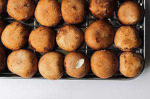 baby bella, or cremini mushrooms on a wire rack lined baking sheet.