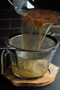 dashi broth being strained into a bowl
