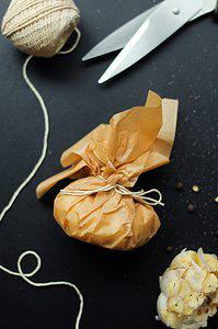 roasted garlic wrapped in parchment paper tied with butchers' twine