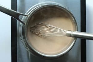 Protein hot chocolate after being heated and whisked in a saucepan.