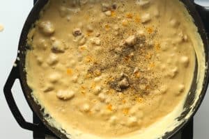 Completed andouille sausage gravy seasoned with salt and pepper.