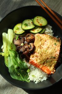 Miso butter salmon over coconut jasmine rice with baby bok choy, sauteed mushrooms, and cucumber salad.