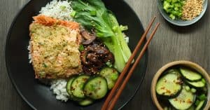 Miso butter salmon with bok choy, mushrooms, cucumber salad, and rice.