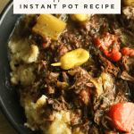 Mississippi pot roast instant pot recipe topped with carrots and peperoncini peppers on heavenlyspiced.com.
